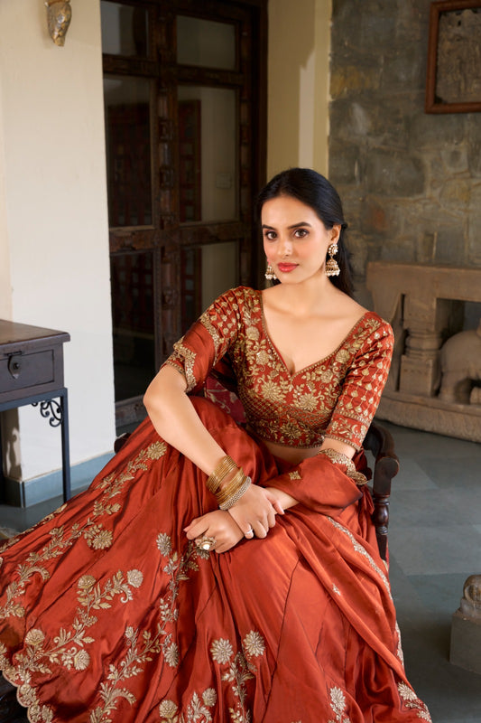 Draped in rust glowing in gold premium lehenga