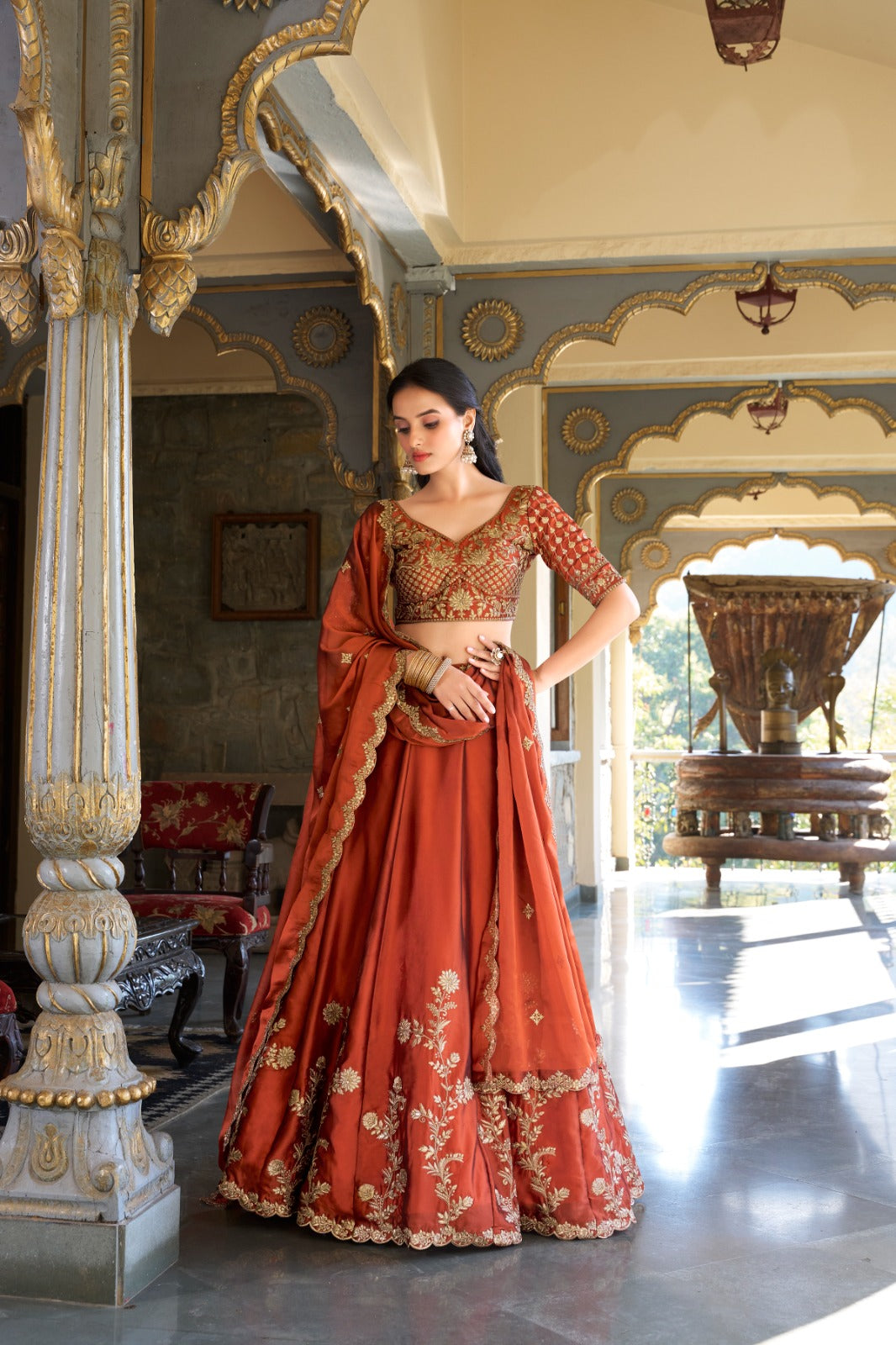 Draped in rust glowing in gold premium lehenga